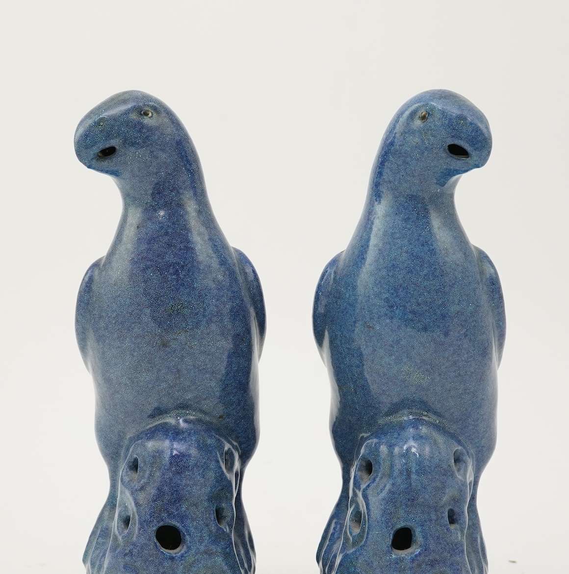 A pair of Chinese blue mottle glazed models of parakeets, 19th century